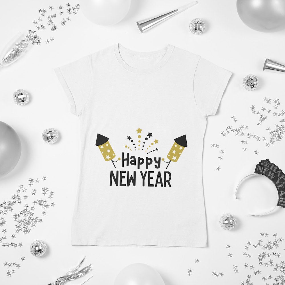 A white t-shirt with 'Happy New Year' text, featuring gold fireworks and rockets, styled with silver party decor and New Year's accessories.